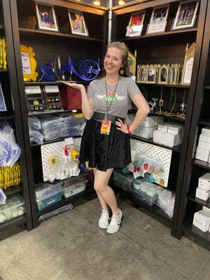 Rachael Beck, the owner of FanCornerCreations, with her bookish merch.