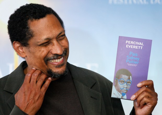 U.S. writer Percival Everett poses with his book " Pas Sidney Poitier " during a photo-call after he was awarded with the Literary Award at the 38th American Film Festival, Wednesday, Sept. 5, 2012, in Deauville, Normandy, France. (AP Photo/Michel Spingler)