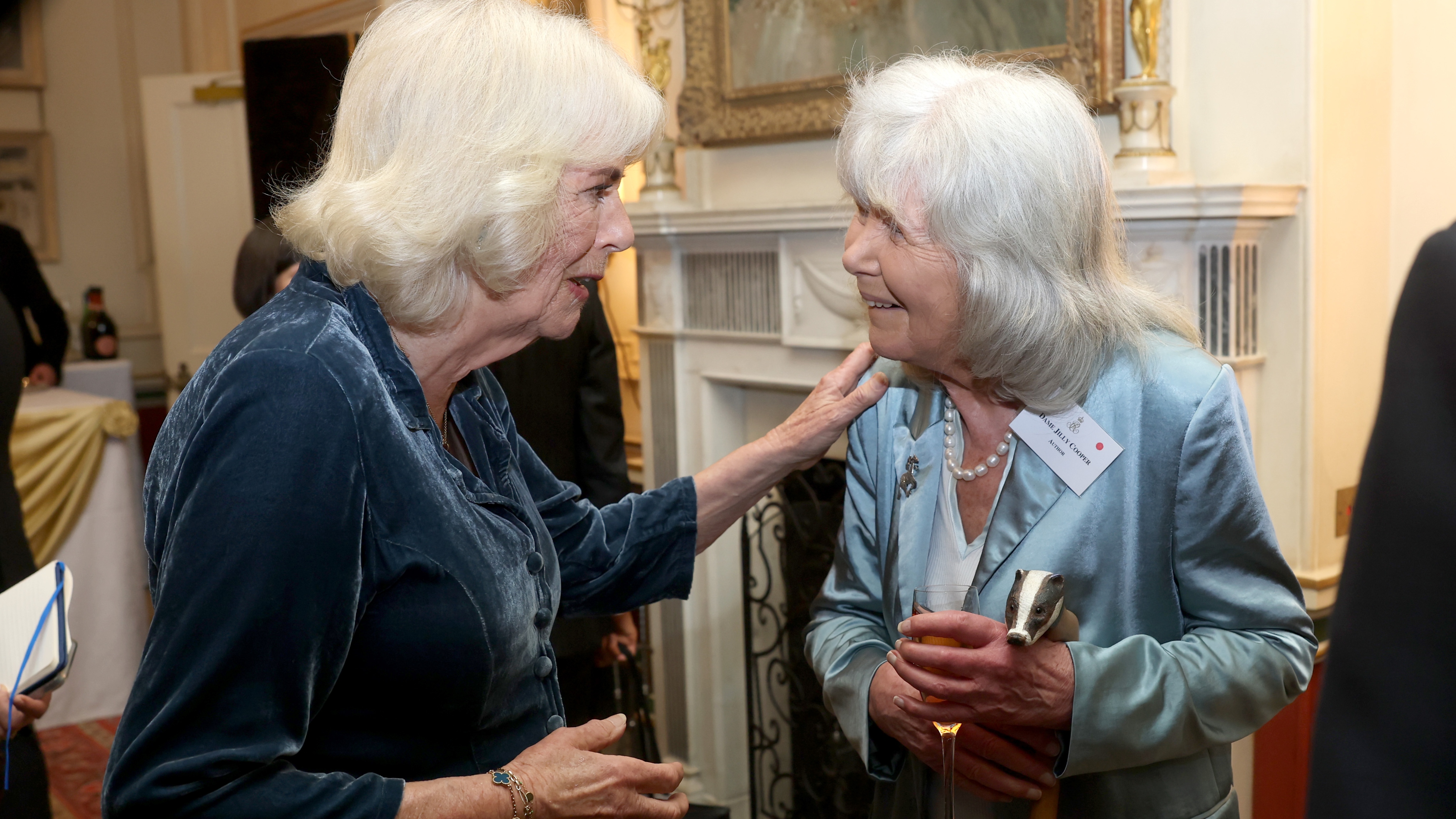 Queen Camilla and Jilly Cooper pose during a reception to mark the launch of the Queen's reading room medal at Clarence House on March 25, 2025 in London, England. Queen Camilla, accompanied by King Charles III, The Duchess of Gloucester, and distinguished authors along with members of the literary community, came together to celebrate the continued efforts of The Queen's Reading Room and its mission to inspire greater reading among people. (Photo by Chris Jackson/Getty Images)